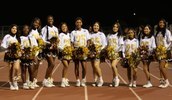 Before the Varsity game starts, The seniors pose for a picture. The seniors soon will have a special dance during halftime dedicated to them, they will be the only ones on the cheer team to perform. 